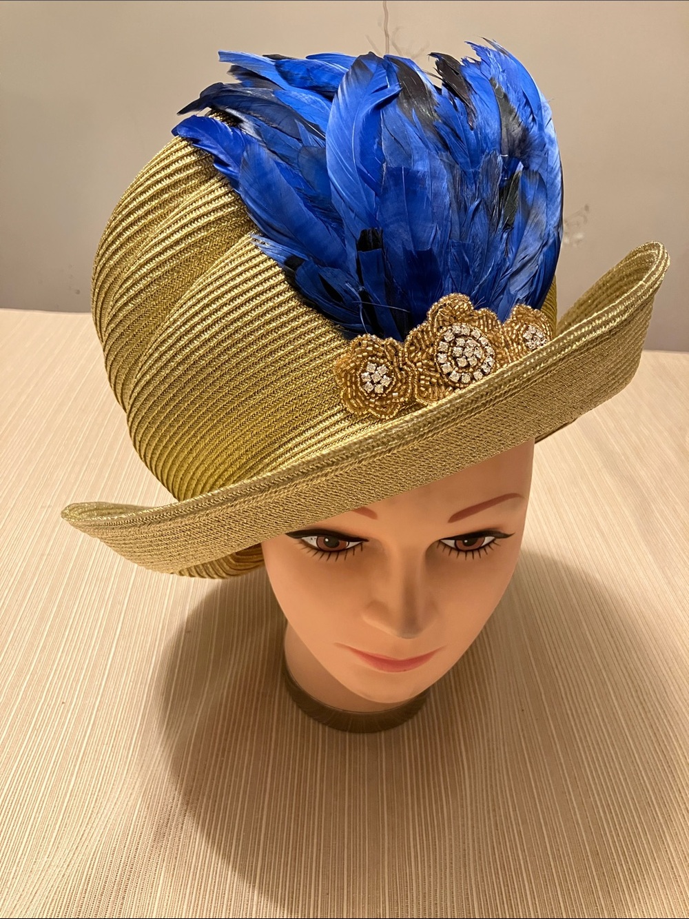 Chic Metallic Gold Straw Hat with Blue Feather Accent